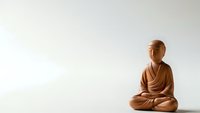 Wooden Buddha statue in meditation pose on neutral background for spiritual and wellness design projects.
