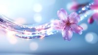 Delicate pink cherry blossom with water drops floating on magical light waves against soft blue bokeh background, creating dreamy spring atmosphere.
