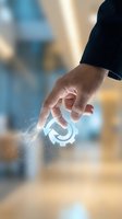 Businessman hand touching glowing digital circular icon with sparkling effects in modern office environment for technology and innovation concepts.