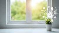 Smart home technology concept with digital icons floating above potted plant on bright windowsill showcasing connected living automation systems.
