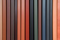 Vertical lines in muted orange, gray and black create modern minimalist pattern with soft gradient transitions. Abstract architectural background for design projects.