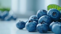 Fresh blueberries with water droplets on clean white surface for healthy eating and nutrition concepts in modern kitchen setting.