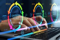 Software development lifecycle concept with hands typing on laptop showing continuous feedback loop, deploy, test, review phases for agile methodology.