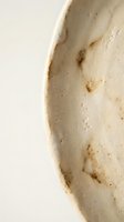 Handmade ceramic bowl with natural speckled glaze and organic texture. Artisan pottery piece showcasing rustic craftsmanship and earthy tones for home decor.