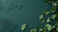 Green ginkgo biloba leaves scattered on dark teal background with golden sparkles creating elegant botanical composition for wellness and nature designs.