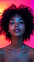 Young African American woman with natural curly afro hair in neon lighting, vibrant pink and blue color gel effects create dramatic portrait with glowing skin and confident expression.