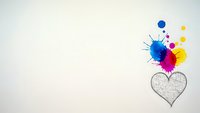 Colorful paint splashes bursting from heart outline on clean white background for creative design projects and artistic concepts.