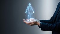 Businessman in dark suit holding glowing digital human body hologram, representing healthcare technology, medical innovation, and futuristic wellness solutions for presentations.