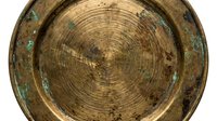Weathered wooden log cross section with concentric growth rings and aged patina, showing natural decay and oxidized copper accents for rustic home decor or design projects.