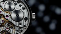 Luxury mechanical watch movement with exposed gears and intricate details on dark background for precision timepiece and craftsmanship concepts.