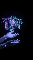Glowing digital brain with neural networks floating above open hands on dark background for artificial intelligence and technology concepts.