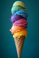 Colorful rainbow ice cream scoops stacked high in waffle cone against dark teal background, featuring vibrant yellow, orange, pink, purple, blue, and green flavors.
