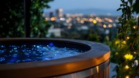 Illuminated hot tub with blue LED lights on rooftop terrace overlooking city lights at dusk, creating luxurious outdoor spa atmosphere with bokeh effect.