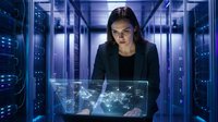 Young Caucasian female IT engineer works with holographic interface in glowing server room, managing data center network infrastructure.