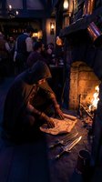 Hooded figure studying ancient map by fireplace in medieval tavern with warm candlelight and atmospheric stone interior for fantasy storytelling.