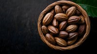 Fresh whole pecans in woven basket on dark background with green leaf. Natural organic nuts composition for healthy snacking and cooking.