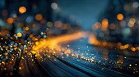 Abstract digital light trails with golden sparks and bokeh effects creating dynamic motion blur against dark blue background for technology concepts.