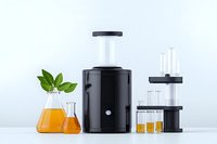 Laboratory glassware with orange liquid, green plant leaves in vase, and modern black scientific equipment on white background for research and testing analysis.