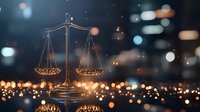 Glowing scales of justice against blurred city lights background with bokeh effect creates atmospheric legal concept for law firm presentations and websites.