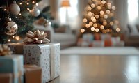 Wrapped gift box with bow on wooden floor against blurred Christmas tree and festive bokeh lights creating cozy holiday atmosphere at home.