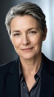 Professional mature Caucasian businesswoman with gray hair in corporate attire smiling confidently for executive leadership and business portraits.