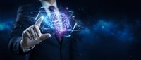 Businessman in suit holding glowing digital brain hologram with neural network connections, representing artificial intelligence, innovation, and technology solutions for business applications.
