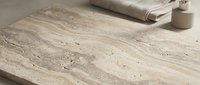 Natural travertine marble stone surface with flowing veins and organic patterns for luxury interior design and architectural applications.