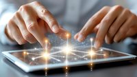 Hands touching digital tablet screen with glowing connection points and sparkles, representing digital transformation and modern technology interface.