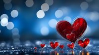 Red glass hearts on reflective surface with blue bokeh background, romantic Valentine concept for love cards and anniversary celebrations.