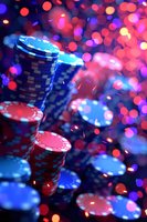 Stack of blue and red poker chips against vibrant bokeh background with colorful lights creating atmosphere of casino gaming excitement.
