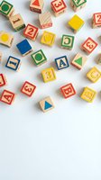Colorful wooden alphabet blocks with letters and numbers scattered on white background for educational play and learning activities.