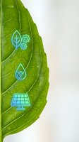 Green leaf with blue eco-friendly technology icons including solar panel, water drop, gears and plant symbols representing sustainable innovation and environmental solutions.