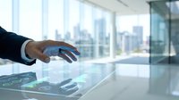 Business professional using interactive touchscreen display in modern office with city skyline view for digital presentations and corporate meetings.