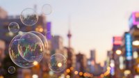 Soap bubbles floating over blurred city skyline at sunset with warm bokeh lights creating dreamy urban atmosphere for creative projects and designs.