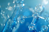 Molecular structure model with transparent glass spheres connected by rods against blue background with bokeh light effects.