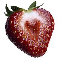 Fresh ripe strawberry with water droplets on glossy red surface, isolated on white background, macro close-up showing natural texture and seeds.