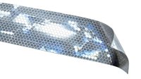 Close-up of reflective safety tape with hexagonal pattern and blue-white light reflections, used for vehicle visibility and protective applications.