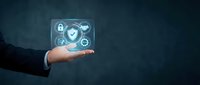 Businessman hand holding digital security shield with checkmark and lock icons on dark blue background for cybersecurity and data protection concepts.