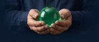 Hands holding green globe symbolizing environmental protection, sustainability, and corporate responsibility for eco-friendly business concepts.