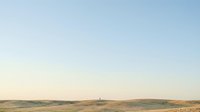 Wind turbines generating renewable energy across vast desert landscape under clear blue sky for sustainable power production and environmental projects.