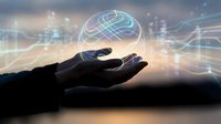 Hand holding glowing digital brain with neural network connections representing artificial intelligence, machine learning and futuristic technology concepts.