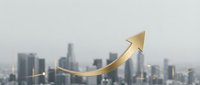 Golden arrow pointing upward over blurred city skyline representing business growth, success, financial progress and economic development in urban environment.