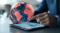 Businessman holding glowing digital globe with world map over tablet showing global business connectivity and international technology networks.