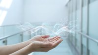 Cupped hands releasing flowing energy waves in modern office corridor representing innovation, creativity and digital transformation concepts.