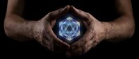 Protective hands cupping glowing blue geometric crystal with sacred geometry patterns against dark background for spiritual and mystical concepts.