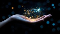 Magical glowing particles and sparkles floating above open palm against dark background with bokeh lights, concept of dreams, magic and wonder.