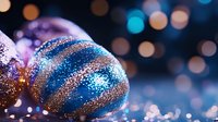 Festive Easter egg decorated with blue and gold glitter pattern on dark background with bokeh lights and magical sparkle effect. Holiday celebration concept.