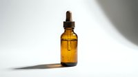 Amber glass dropper bottle filled with golden liquid oil serum on white background with shadow, suitable for cosmetics, skincare, wellness and beauty product packaging mockups.