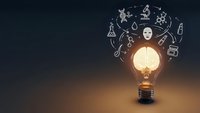 Glowing light bulb with scientific icons floating above representing innovation, research, discovery and creative thinking for educational content.