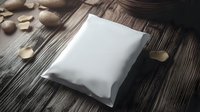 Blank white foil package mockup on rustic wooden background with scattered cashew nuts, ready for product design and branding presentation.
